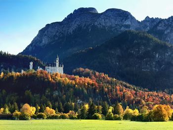 Scenic view of trees and mountains against sky with castle