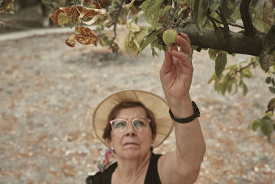 Portrait of woman holding plant