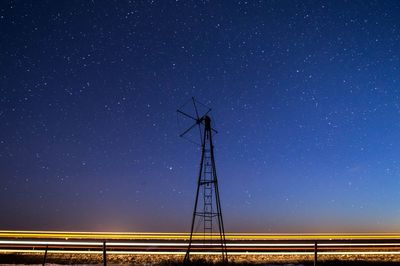 Low angle view of windmill against sky at night