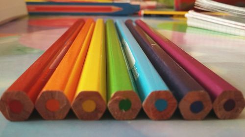 Close-up of multi colored pencils on table