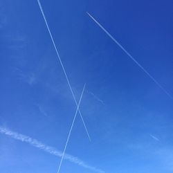 Vapor trail against blue sky