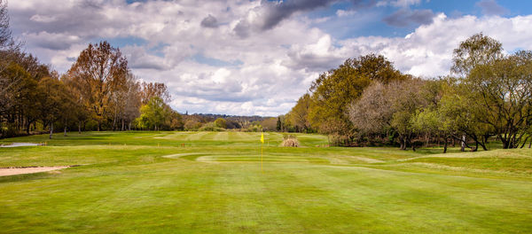 Panoramic view of golf course against sky