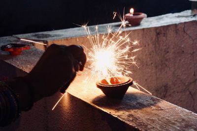 Person holding lit candles