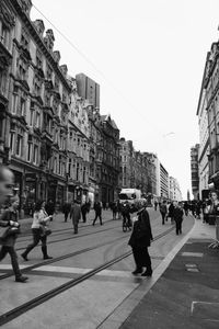 People on road in city against clear sky