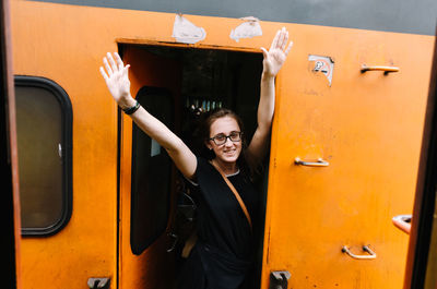 Portrait of smiling young woman in bus