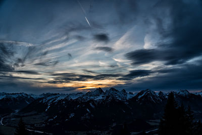 Scenic view of snowcapped mountains against sky during sunset