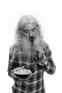 Portrait of man standing against white background