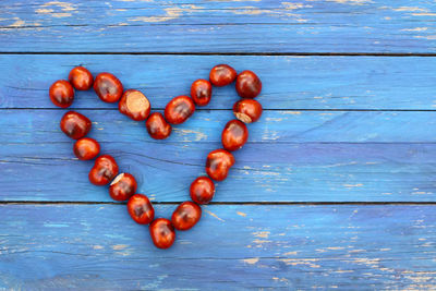 Directly above shot of nuts arranged in heart shape on table