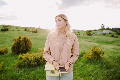 Young woman looking at camera on field