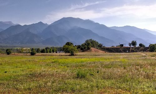 Scenic view of landscape and mountains against sky