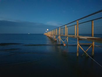 Scenic view of sea against blue sky at dusk