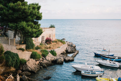 Boats in sea against sky