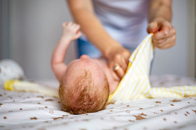 Close-up of man preparing food on bed at home