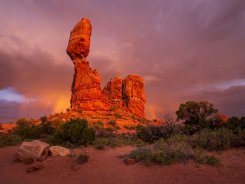  balanced rock in us set with colorful clouds in arches national park, utah.