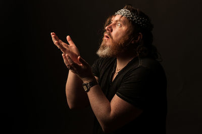 Portrait of man against black background