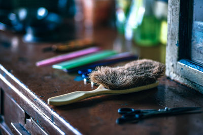 Close-up of weathered brush on table