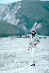 Portrait of young woman standing outdoors