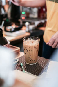 Glass of coffee on table in cafe