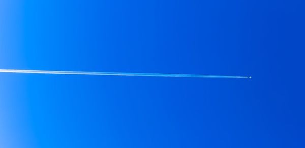 Close-up of vapor trail in blue sky