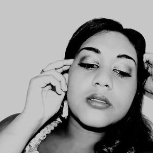 Portrait of beautiful woman against gray background