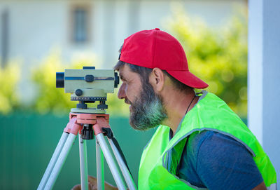 Rear view of man photographing at airport