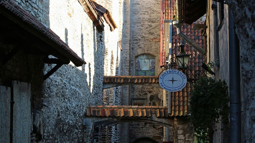 Low angle view of clock hanging on wall