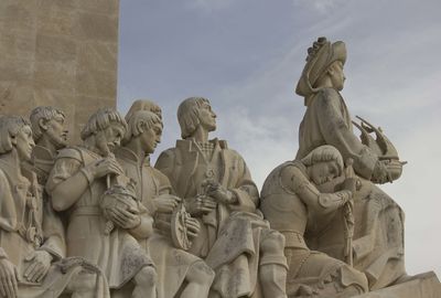 Low angle view of statues against sky