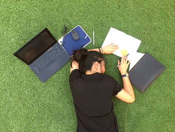 High angle view of woman reading book