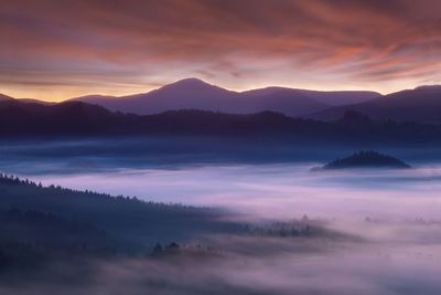 Scenic view of silhouette mountains against sky during sunset