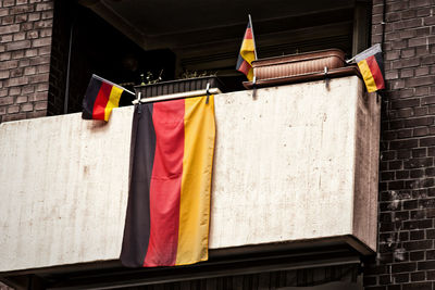 Close-up of german flag hanging on railing