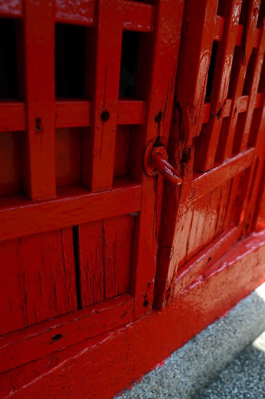 CLOSE-UP OF METAL GATE AGAINST BUILDING