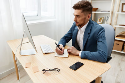 Side view of businessman working on table