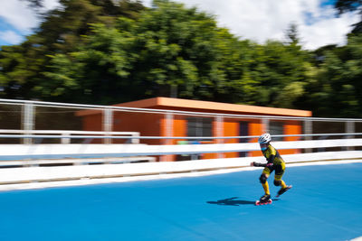 Side view of man skateboarding on road