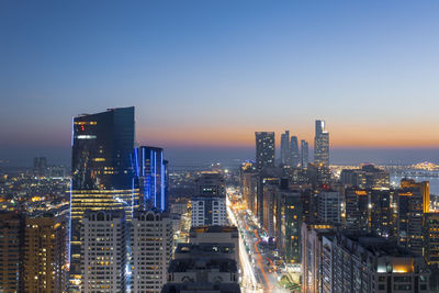 High angle view of illuminated city buildings against sky