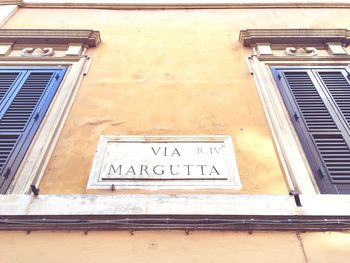 Low angle view of text on window