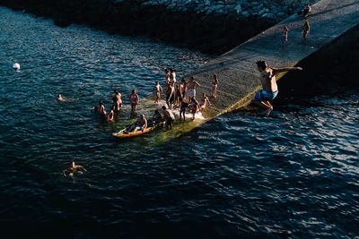 High angle view of people enjoying in lake