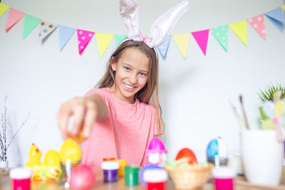 Portrait of girl holding egg