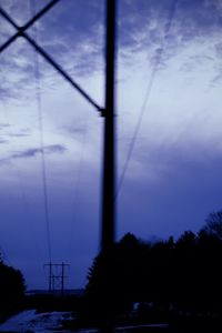 Low angle view of silhouette trees against sky at dusk
