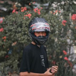 Portrait of boy standing against plants