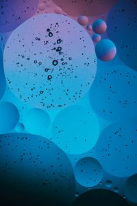 Close-up of bubbles against blue background