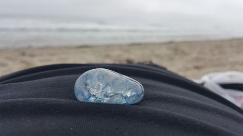 Close-up of water on beach against sky