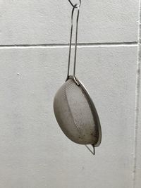 Close-up of white hanging on wall