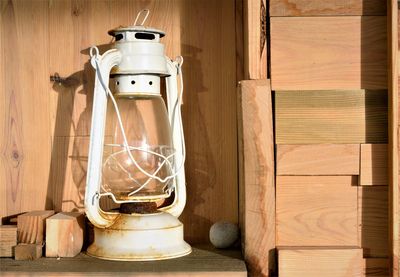 Close-up of wood and old lamp