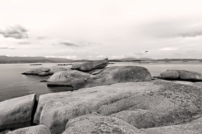 Rocks on beach against sky