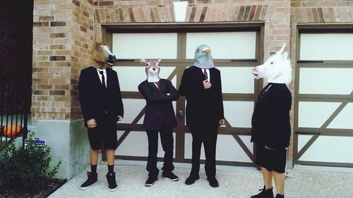 Woman standing by wall