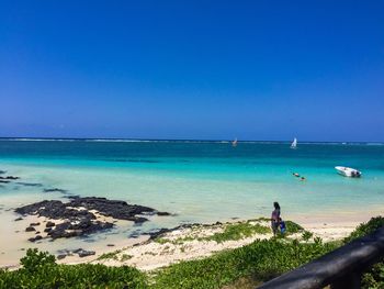 Scenic view of sea against clear blue sky