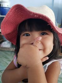 Close-up portrait of cute girl wearing hat