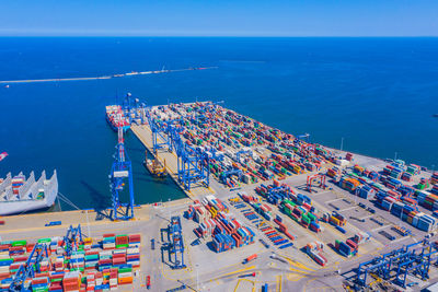 Container ship in export and import logistics. cargo to harbor by crane. international. aerial view 