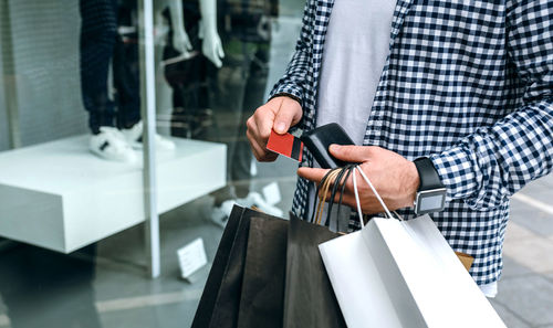 Man holding umbrella while standing in store