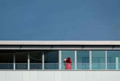 Red bear in balcony against clear sky